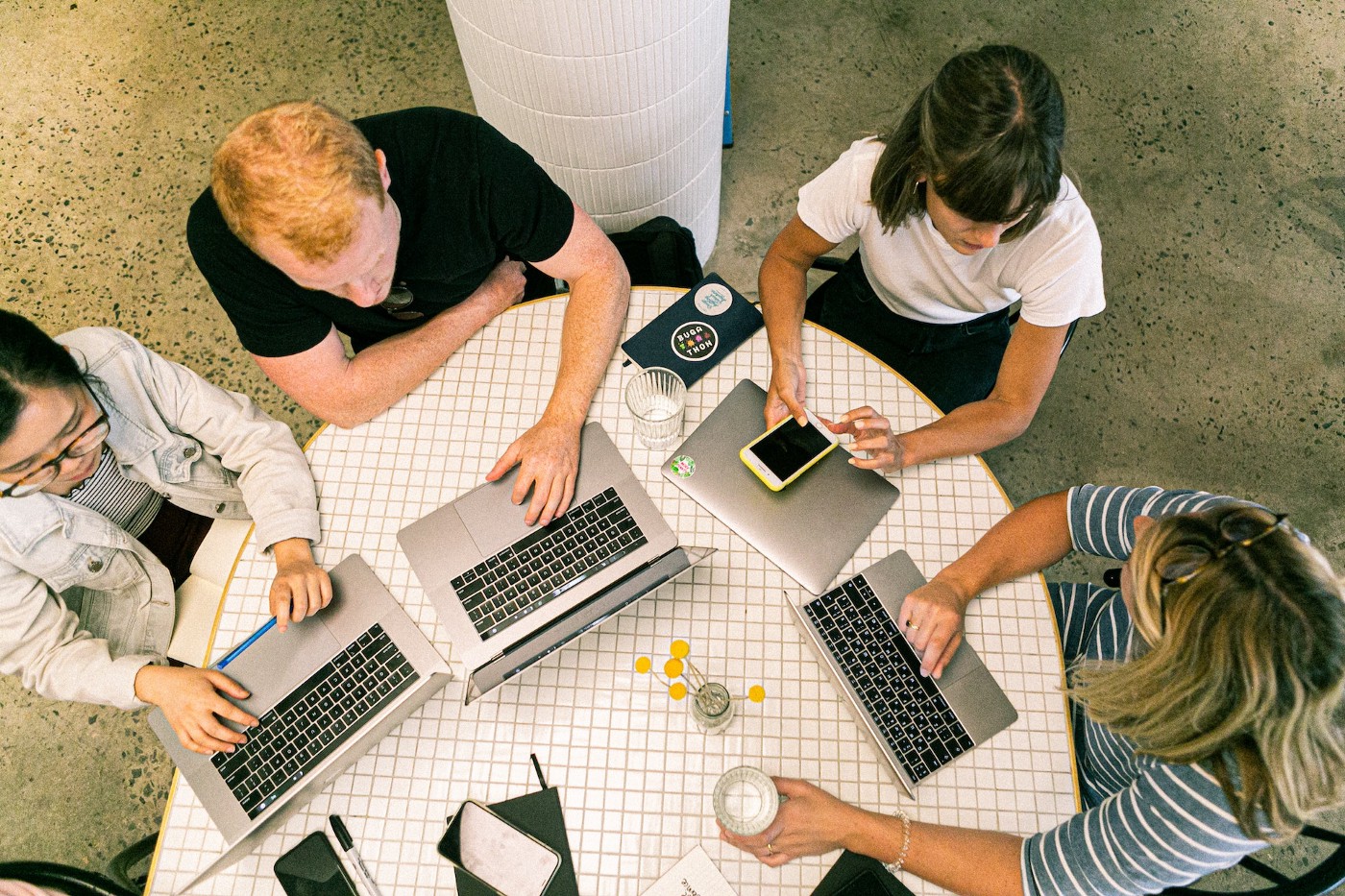 Entrepreneurs in business attire, discussing strategies around a conference table.